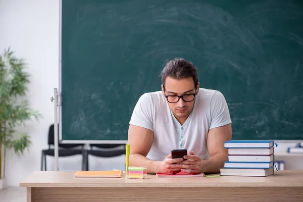 Jeune enseignant étudiant assis dans la classe — Photo