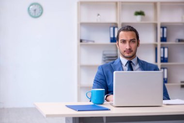 İş yerinde çalışan genç bir erkek.