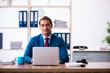 Ofiste çalışan genç bir erkek.