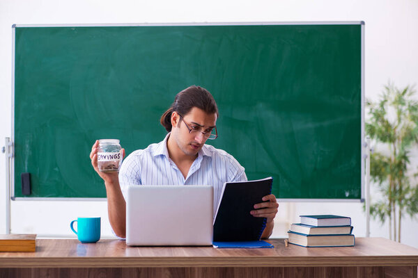 Young male teacher in remuneration concept