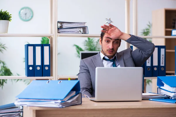 Junge männliche Mitarbeiter und zu viel Arbeit im Büro — Stockfoto