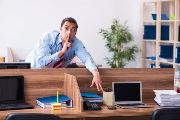 Young male employee in industrial espionage concept — Stock Photo, Image