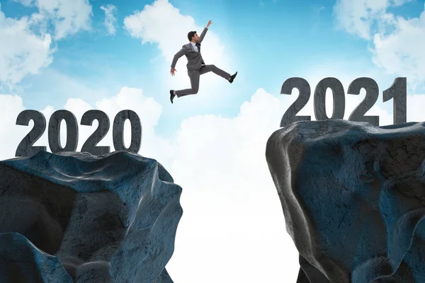 Businessman jumping from the year 2020 to 2021 — Stock Photo, Image