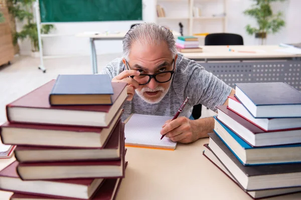 Old male student preparing for exams in the classroom — Stock Photo, Image