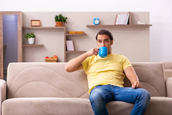 Young man student drinking coffee at home — Stock Photo, Image