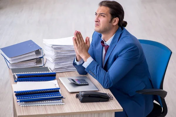 Young male bookkeeper unhappy with excessive work in the office — ストック写真