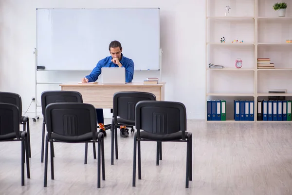 Young male business trainer making presentation during pandemic