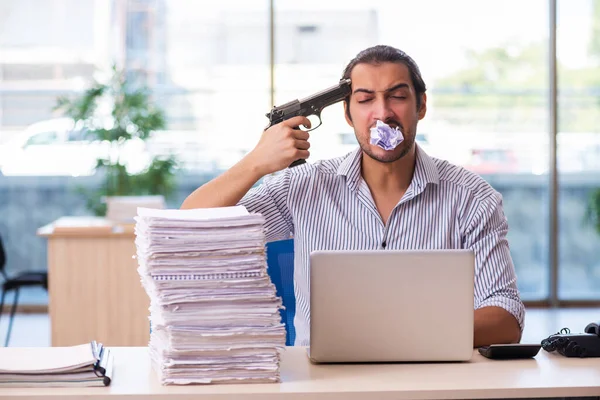 Young male employee unhappy with excessive work in the office — Stock Photo, Image