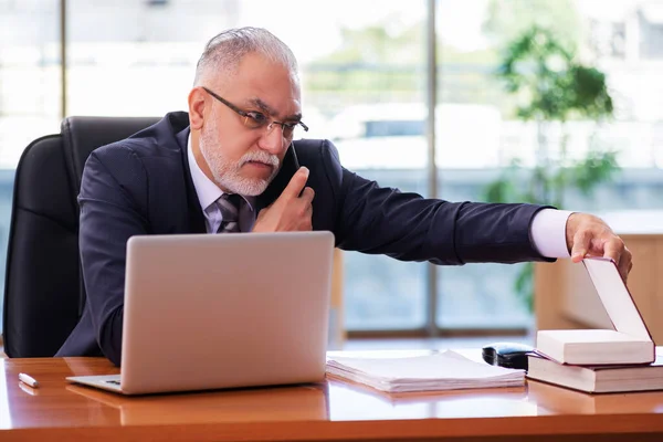 Ein alter Geschäftsmann arbeitet im Büro — Stockfoto