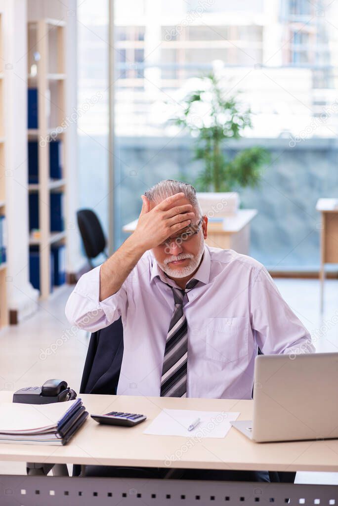 Aged businessman employee unhappy with excessive work