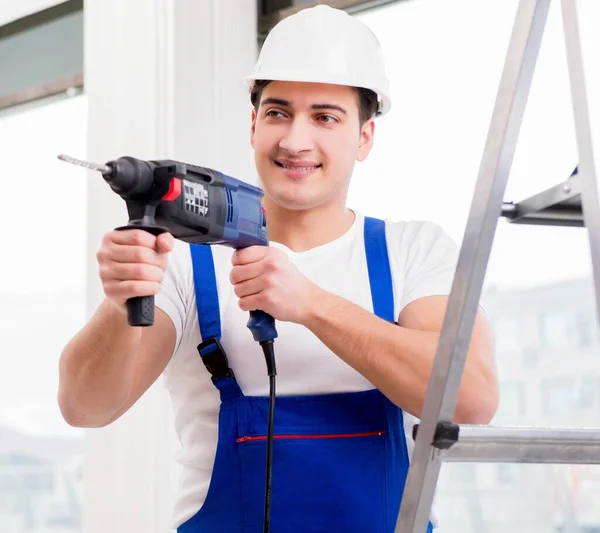 Repairman working with power drill in workshop — Stock Photo, Image