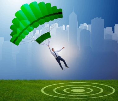 Genç işadamı iş konseptinde paraşütle atlıyor