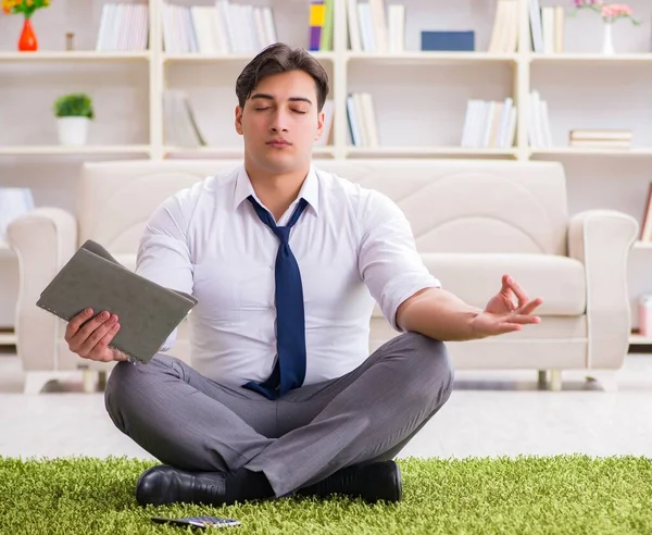 Businessman sitting on the floor in office — Stock Photo, Image