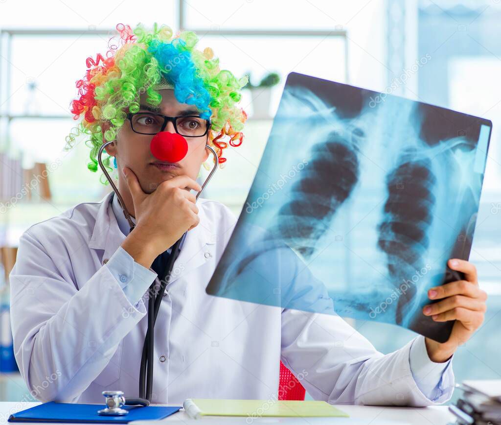 Pediatrician with x-ray image sitting in the office