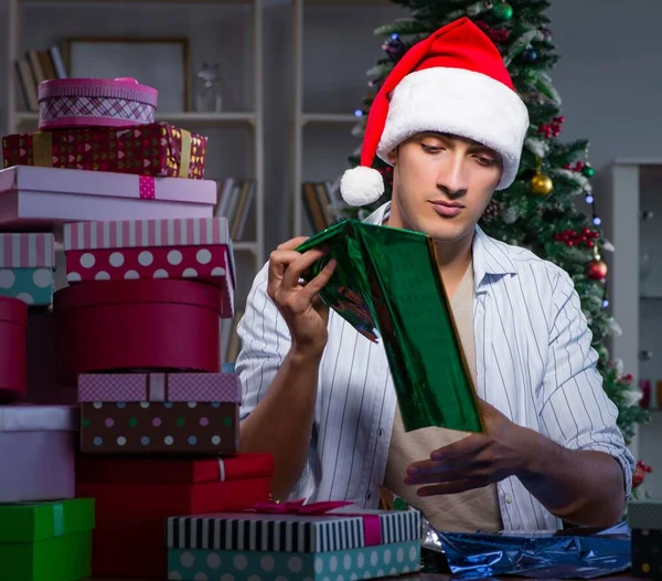 Man with many christmas gifts in boxes — Stock Photo, Image