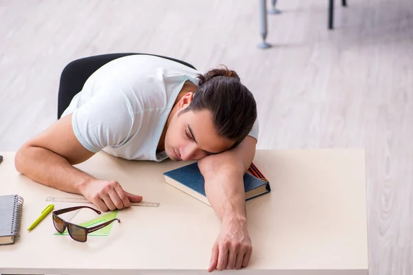 Young male student preparing for exam in the classroom — Stock Photo, Image