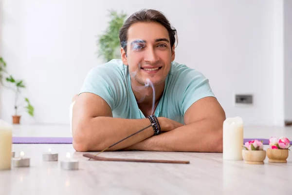 Young man during yoga session at home — Stock Photo, Image