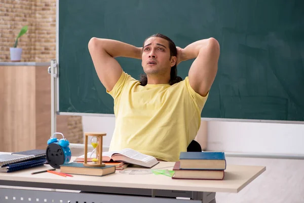 Young male student preparing for exams in the classroom — Stock Photo, Image