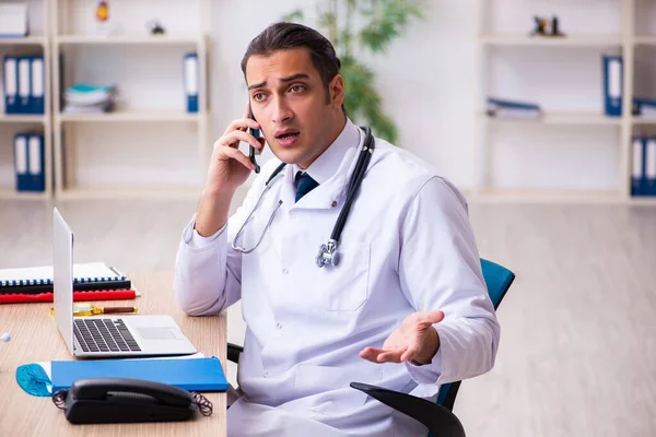 Young male doctor in telemedicine concept — Stock Photo, Image