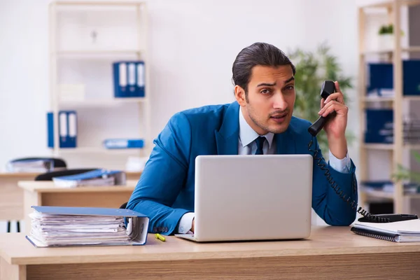 Giovane dipendente maschile e troppi lavorano in ufficio — Foto Stock