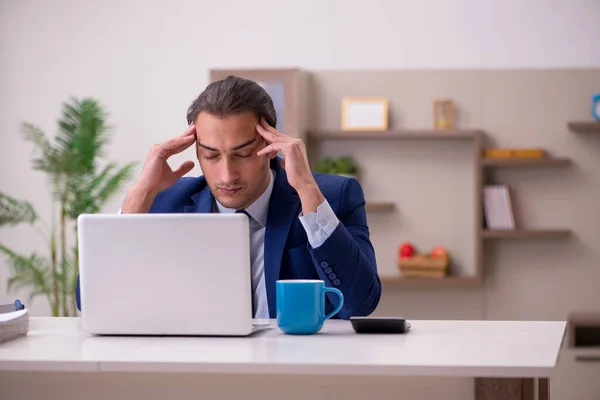 Young male employee working from home in pandemic concept — Stock Photo, Image