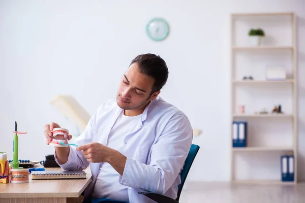 Young male dentist working in the clinic — Stock Photo, Image