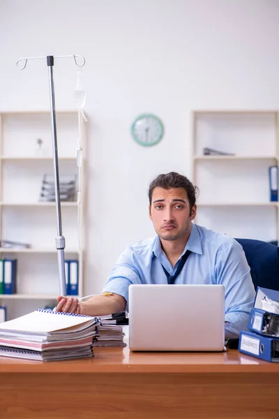 Young male employee suffering at workplace — Stock Photo, Image