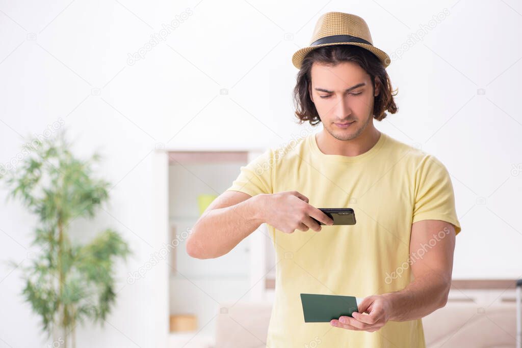 Young man holding passport preparing for summer trip