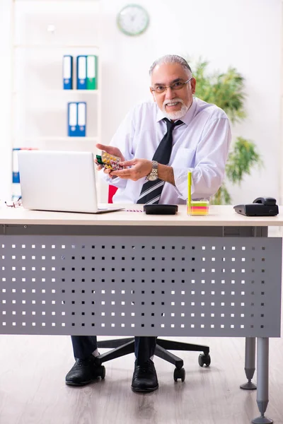 Old sick employee suffering at workplace