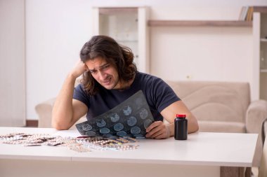 Evde acı çeken genç hasta adam.