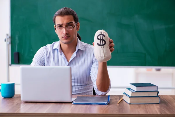 Young male teacher in remuneration concept — Stock Photo, Image
