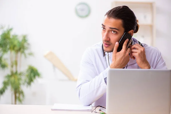 Young doctor listening to patient during telemedicine session — Stock Photo, Image