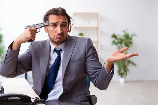 Young male employee unhappy with excessive work — Stock Photo, Image