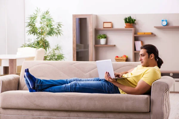 Young man student freelancer in teleworking concept — Stock Photo, Image