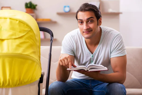 Young male contractor looking after new born at home