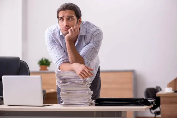 Young male employee unhappy with excessive work — Stock Photo, Image