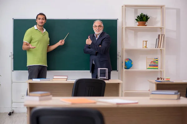 教室で高齢の教師と男性学生 — ストック写真