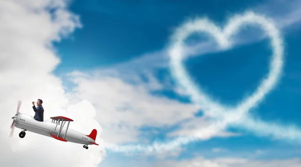 Homem voando avião e fazendo forma de coração — Fotografia de Stock