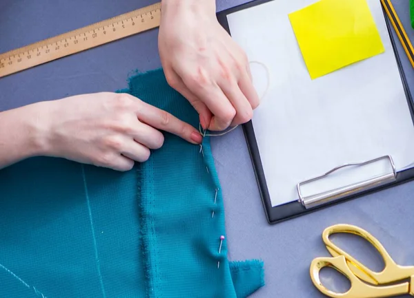 Woman tailor working on a clothing sewing stitching measuring fa — Stock Photo, Image
