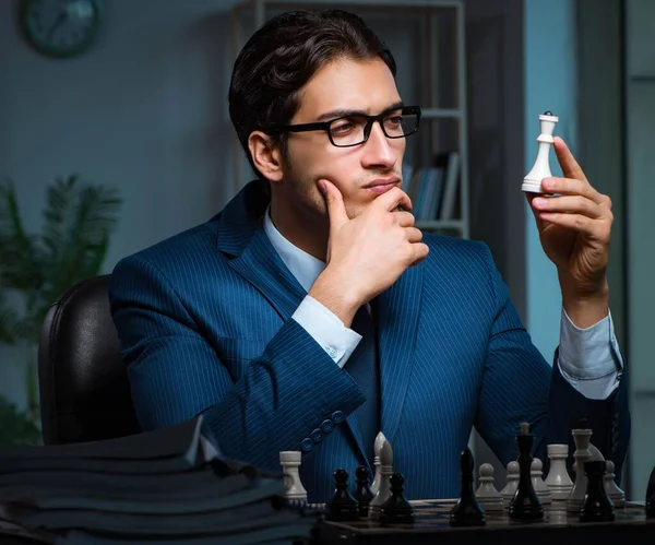 Businessman playing chess in strategy concept — Stock Photo, Image