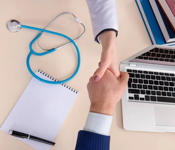 Man signing medical insurance contract