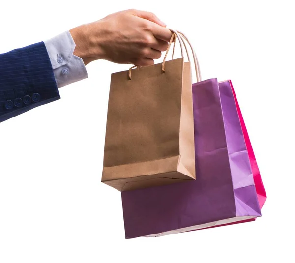 Mano sosteniendo bolsas de compras con compras de Navidad en la espalda blanca —  Fotos de Stock