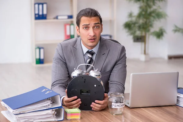 Young male employee in pension concept at workplace — Stock Photo, Image