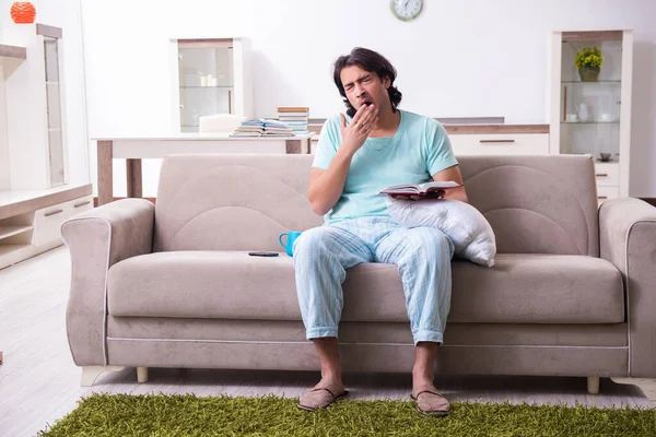 Young male student being tired preparing for exams at home — Stock Photo, Image