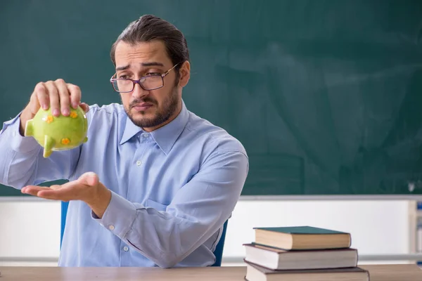 Young underpaid male teacher in the classroom — Stock Photo, Image