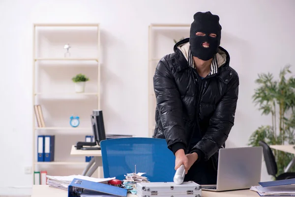 Young male burglar in the office — Stock Photo, Image