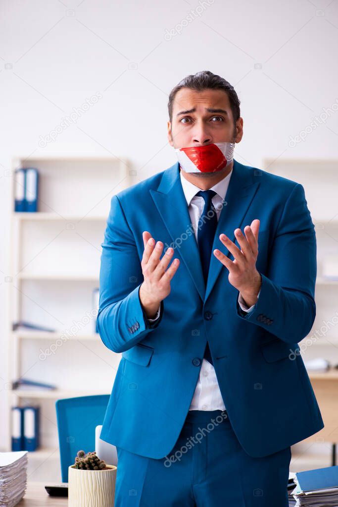 Mouth closed male employee working in the office