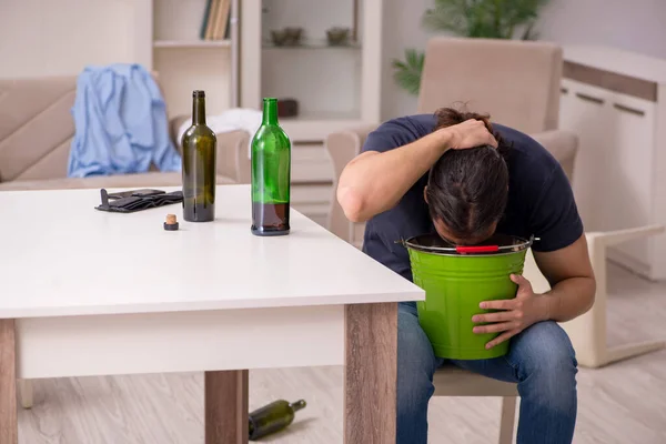 Young alcohol addicted man suffering from stomachache at home — Stock Photo, Image