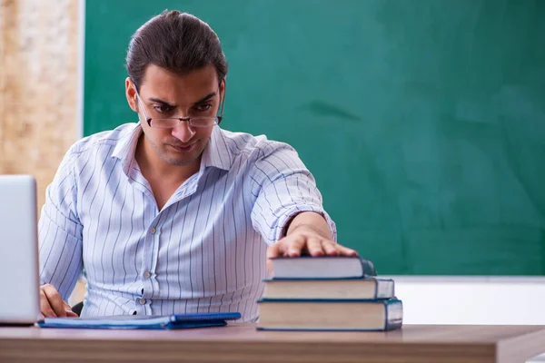 Joven profesor delante de pizarra —  Fotos de Stock