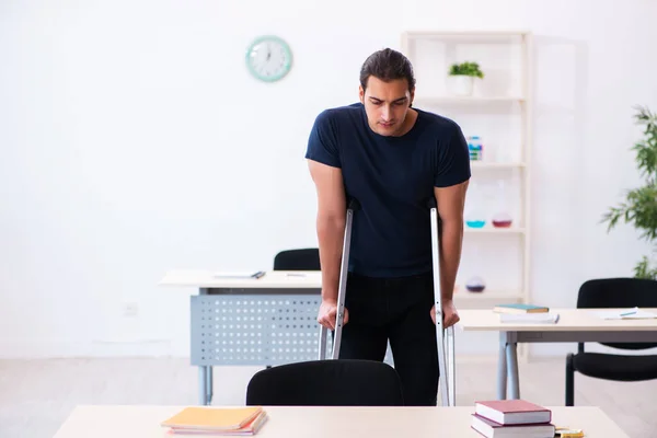 Young male student after accident preparing for exams — Stock Photo, Image